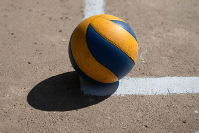 Volleyball ball on blurred concrete background.