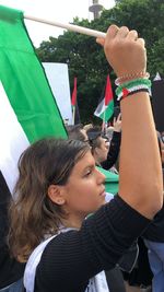 Portrait of a girl with arms outstretched standing outdoors