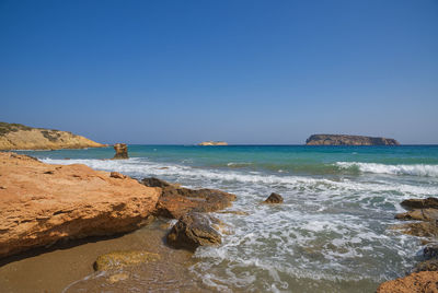 Scenic view of sea against clear blue sky