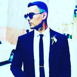 Young man wearing sunglasses standing outdoors
