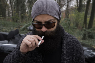 Portrait of man smoking cigarette