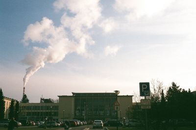 Smoke emitting from chimney against sky