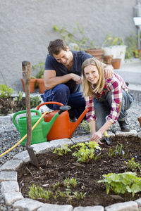 Happy young couple working in garden, stockholm, sweden