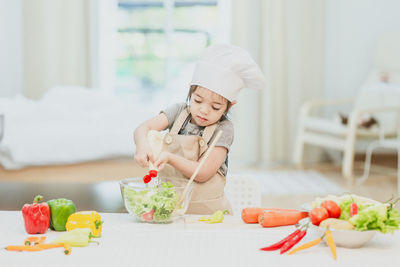 Midsection of man with vegetables on table