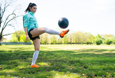 Woman playing with ball on field