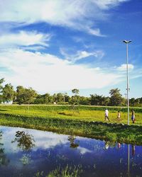 Scenic view of field against cloudy sky