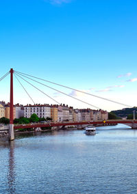 View of bridge over river against blue sky