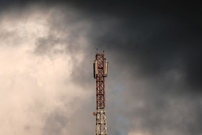 Low angle view of  tower against dark sky
