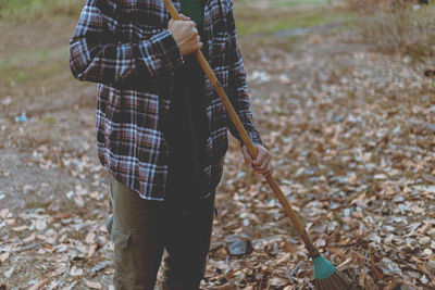 Man holding umbrella on field