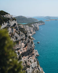 High angle view of rocks on sea against sky