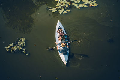 High angle view of people kayaking in lake