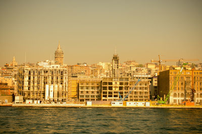 View of buildings at waterfront against clear sky