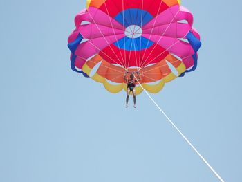 Low angle view of person parasailing