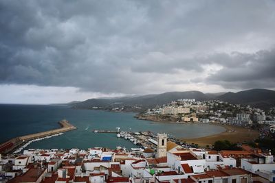 High angle view of buildings by sea against sky