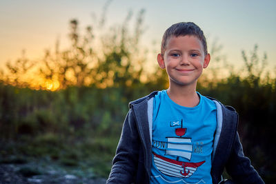 Portrait of smiling boy standing outdoors