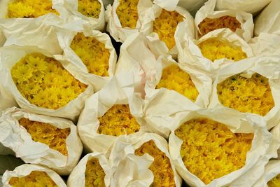 Full frame shot of yellow flower bouquets for sale at market stall