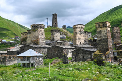 Old village with defensive towers against sky