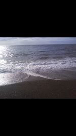 Scenic view of sea against black background