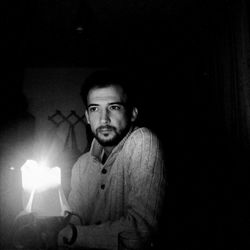 Portrait of young man in darkroom