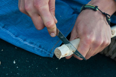 Close-up of man cutting wood