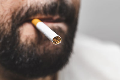 Close-up of man smoking cigarette