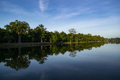 Reflection of trees in lake against sky