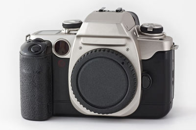 Close-up of camera on table against white background