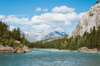 Scenic view of lake and mountains against cloudy sky