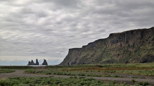 Scenic view of landscape against cloudy sky