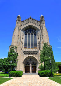 Low angle view of historic building against clear blue sky