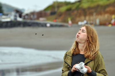 Beautiful woman relaxing in town by sea