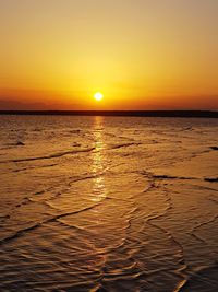 Scenic view of sea against romantic sky at sunset