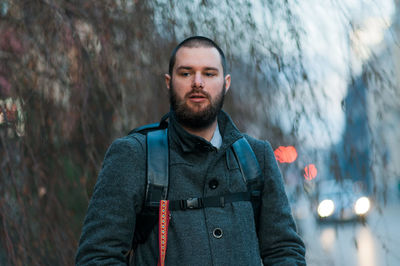 Man with backpack standing outdoors during winter