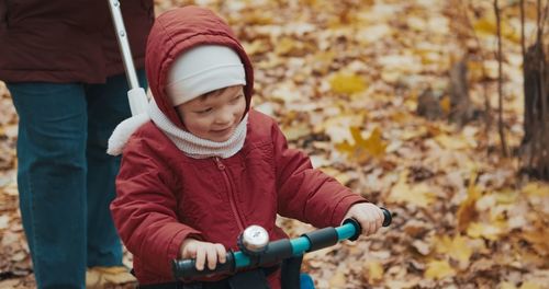 Portrait of cute baby boy standing in park