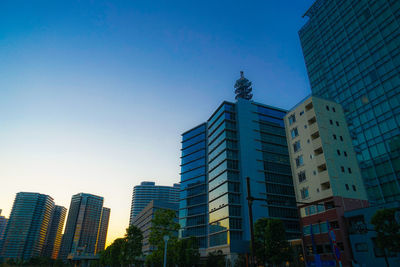 Low angle view of buildings against clear blue sky