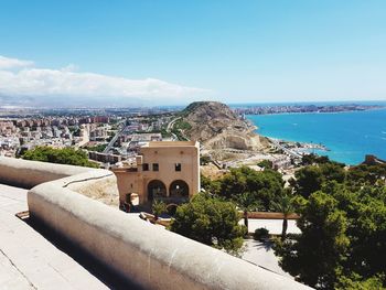 View of townscape by sea against sky