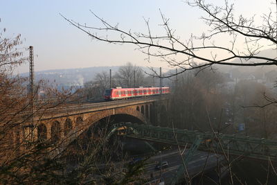 Train on bridge against sky