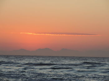 Scenic view of sea against orange sky