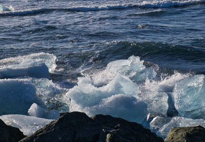 Sea waves splashing on rocks