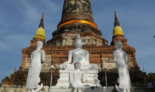 Low angle view of statue against temple