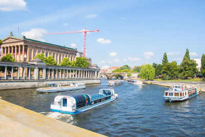 View of boats in river against buildings