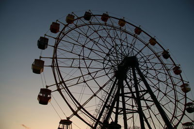 Low angle view of ferris wheel against sky