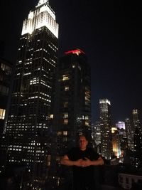 Illuminated cityscape against clear sky at night