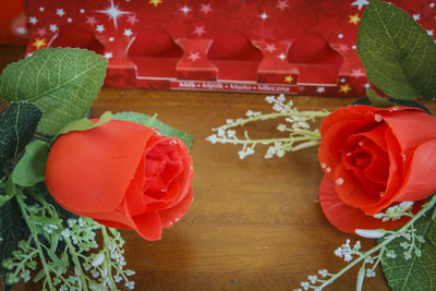 Close-up of red rose on table