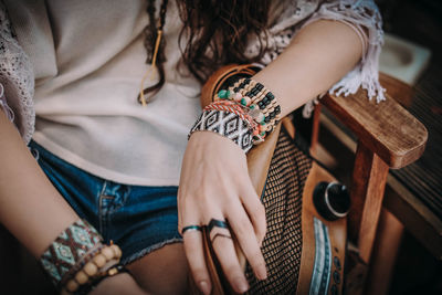 Female hands with boho accessories bracelets made of colored beads