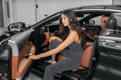 Woman standing in car