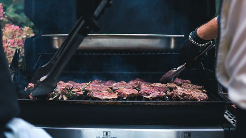 Man preparing food on barbecue grill