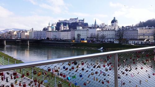 Bridge over river in city against sky