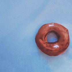 High angle view of ice cream on blue table against wall