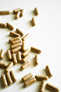 Close-up of pills over white background